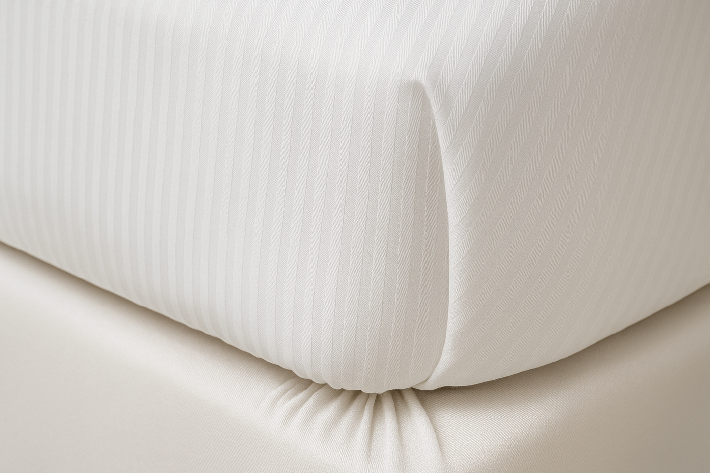 Close-up of fitted sheet corner with vertical stripes